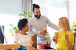 © Syda Productions - business team with coffee cups talking at office