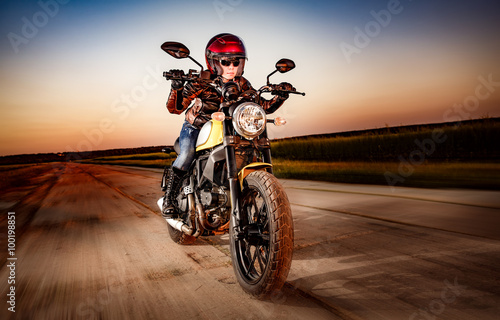 Naklejka na drzwi Biker girl on a motorcycle