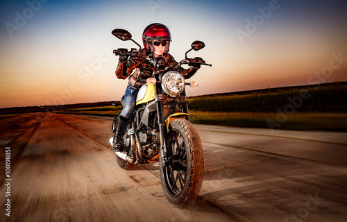 Fototapeta na wymiar Biker girl on a motorcycle