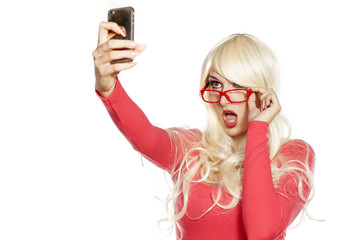 Sexy blonde takes selfies with her smartphone