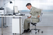 Accountant Suffering From Back Pain At Desk