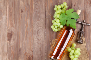 Bunch of grapes, white wine bottle and corkscrew