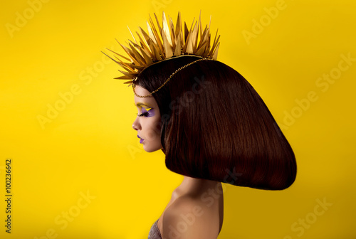 Fotomural The avantaged portrait girl with an unusual make up , Portrait on a yellow backg