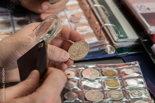Two numismatists examines collection of coin Poster