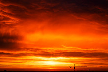 Red Sunset In Blue Cumulus Clouds