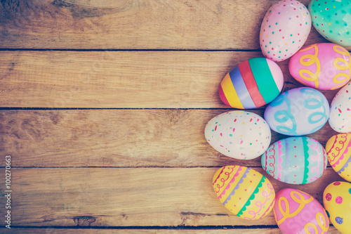 Easter eggs on wooden background with vintage tone. Poster