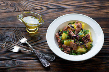 Poster - Glass plate with octopus salad on a rustic wooden background