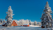 © knowlesgallery - Fresh snow blankets a country Idaho farm with red barn