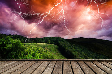 Wall Mural - thunderstorm with lightning in green meadow