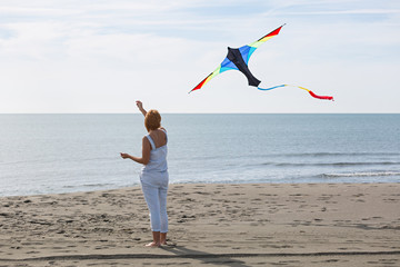 redheaded model holding kite and posing 