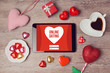 Online dating cocept with digital tablet mock up and heart chocolates. Valentine's day romantic celebration. View from above