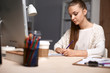 © shefkate - Young woman working in office, sitting at desk