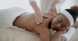© Dash - Female therapist's hands doing back massage on woman