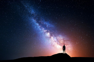 Wall Mural - milky way. night sky with stars and silhouette of a man