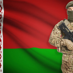 Soldier with machine gun and flag on background - Belarus