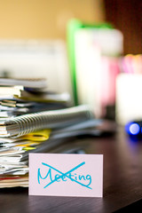 No Meeting; Stack of Documents and Laptop at working Desk.