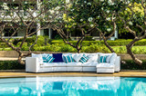 Fototapeta  - Outdoor sofa with cushions and pillows in the garden by the pool
