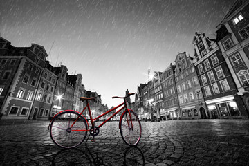 Fototapete - Vintage red bike on cobblestone historic old town in rain. Wroclaw, Poland.