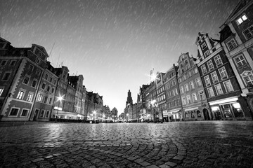 Fototapete - Cobblestone historic old town in rain at night. Wroclaw, Poland. Black and white