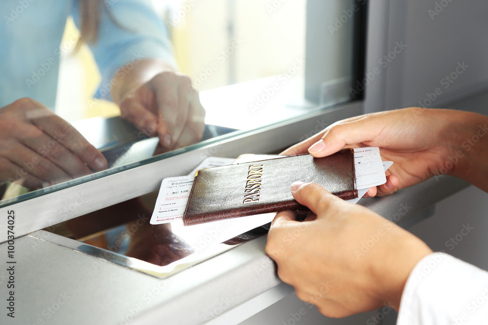 Woman buying tickets with passport at box office