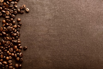 Canvas Print - Roasted coffee beans on grey textile background