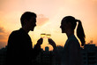 © kieferpix - Young couple celebrating with glass of wine in the city.