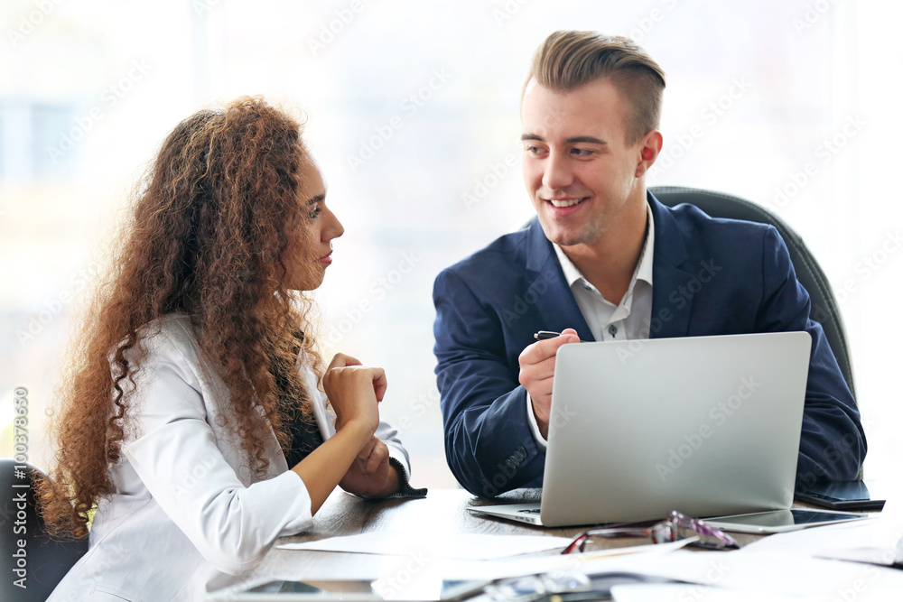 Businessman and businesswoman working in office