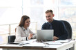 © Africa Studio - Businessman and businesswoman working in office