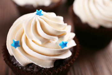 Chocolate cupcakes on wooden background, closeup