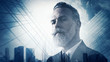 © SFIO CRACHO - Portrait of bearded gentleman in suit and double exposure skyscraper on the background.