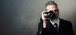 © SFIO CRACHO - Portrait of bearded gentleman makes the photo on a retro camera. Wide