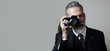 © SFIO CRACHO - Portrait of bearded gentleman makes the photo on a classic camera. Wide