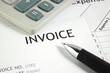 Invoice letter head with pen and calculator / selective focus