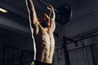 © baranq - Closeup of young man lifting barbells at gym