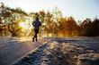 © baranq - Young man running at park during cold winter morning.