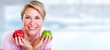 © grinny - Mature smiling woman with apple.