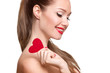 Love and valentines day woman holding heart smiling cute. Portrait of Beautiful woman with bright makeup and red heart in hand
