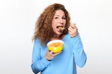 Vivacious Young Woman Eating Breakfast Cereal