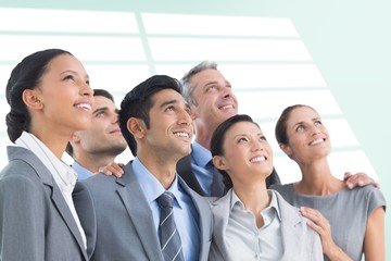 Wall Mural - Composite image of business people looking up in office