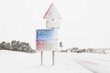 Snow covered road sign