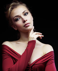 Wall Mural - beautiful rich blond woman in elegant dress on black background close up