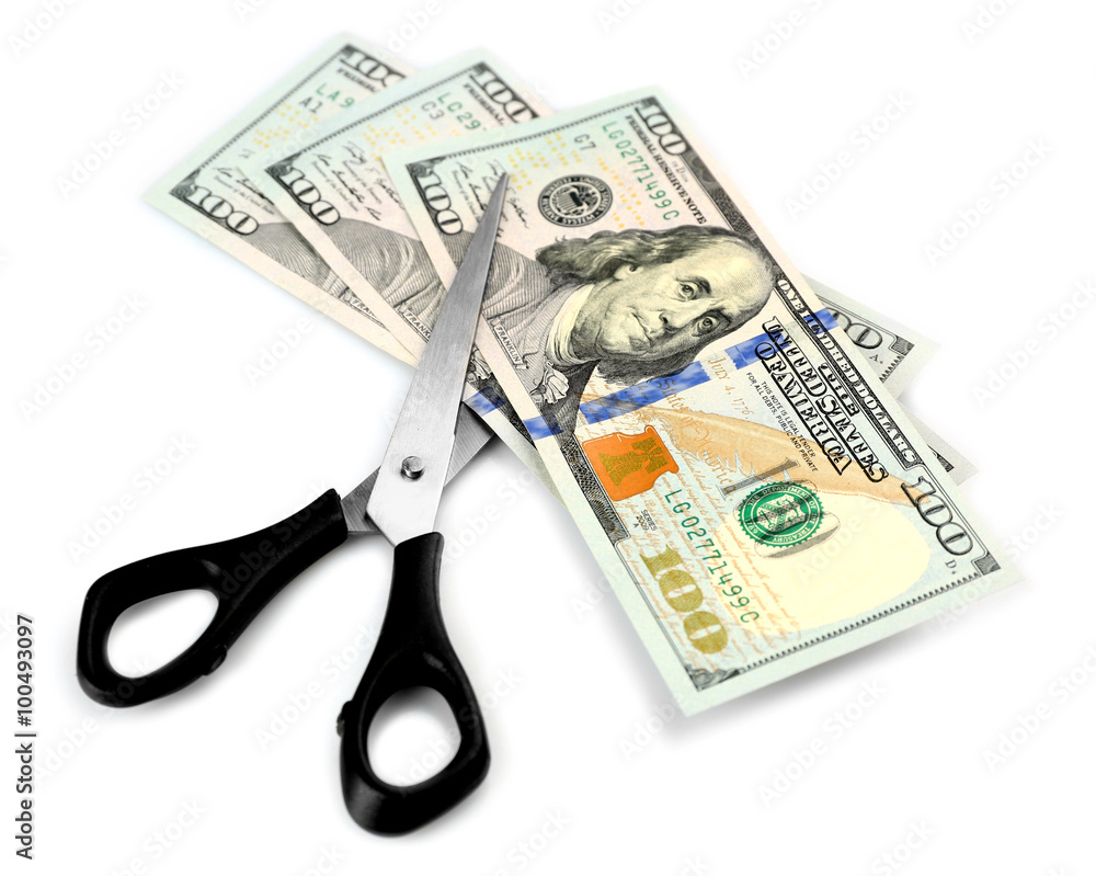 Scissors cut dollar banknotes, isolated on white