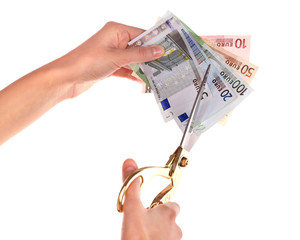 Poster - Hands with scissors cutting Euro banknotes, isolated on white