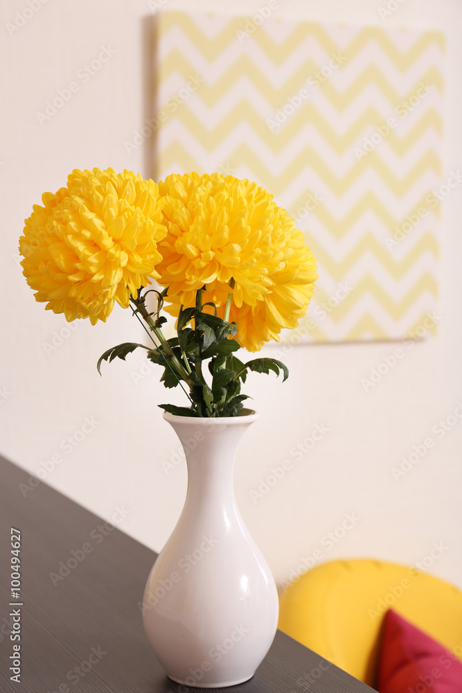 Vase with beautiful chrysanthemum on the table, close up