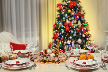  Christmas table setting with holiday decorations background
