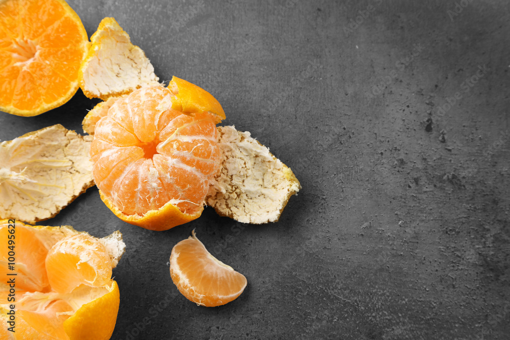 Bowl with fresh tangerines on dark metal table, close up