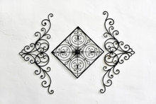 Decorative Wrought Iron Hanging On The White Wall