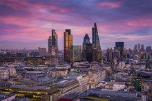 Skyline Of Business District Of London At Dusk With Beautiful Colorful Sky And Canary Wharf At The Background