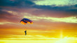 Skydiver On Colorful Parachute In Sunny Sunset Sky. Active Hobbi