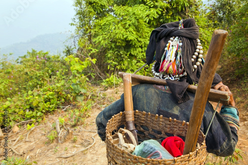Fotografie, Obraz Akha villager carry things on her back in mountain, Laos
